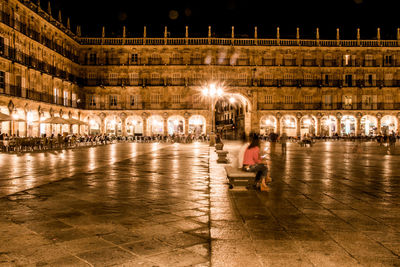 People at illuminated city at night