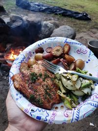 High angle view of hand holding food in plate