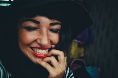 Close-up portrait of a smiling young woman eating