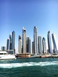 Modern buildings in city against clear sky