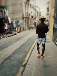 Rear view of man walking in city