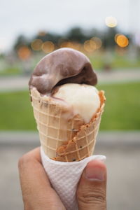 Close-up of hand holding ice cream cone