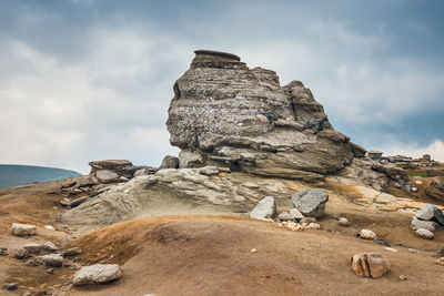 Low angle view of rock formations against sky