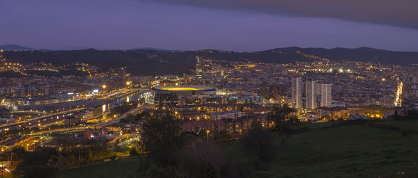 High angle view of illuminated cityscape against sky at night