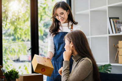 Side view of young woman using laptop