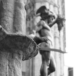 Close-up of hand feeding statue