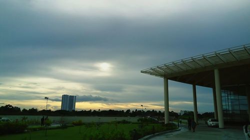 Buildings in city against cloudy sky