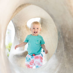 High angle view of boy standing in tunnel