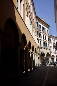 People walking on street amidst buildings in city