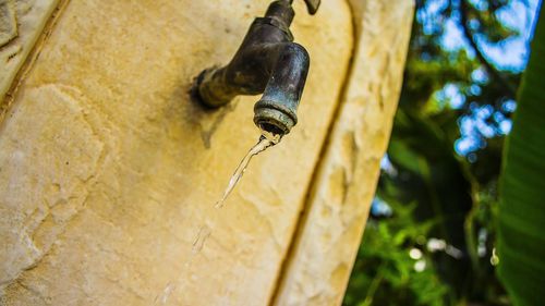 Close-up of faucet hanging outdoors