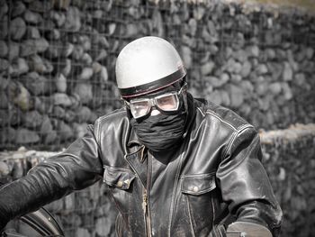 Man wearing mask and helmet outdoors