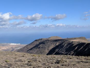 Scenic view of rock formations against blue sky