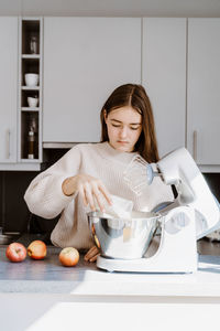 Young woman preparing food on table