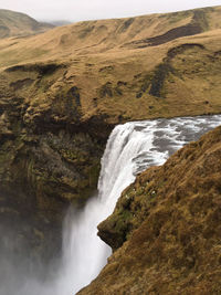 Scenic view of waterfall against sky