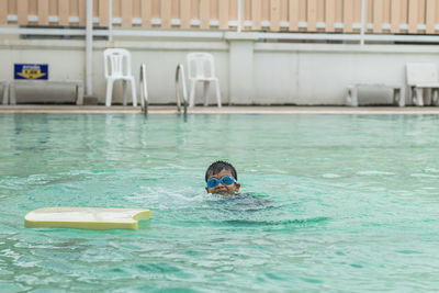 Boy swimming in pool