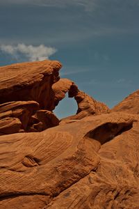 View of desert against cloudy sky