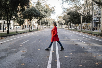 Rear view of woman with umbrella on street