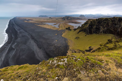 Scenic view of mountains against cloudy sky