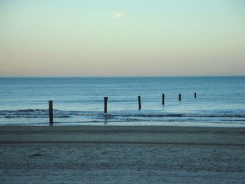 Scenic view of beach against sky during sunset