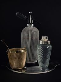 Close-up of metal structure on table against black background