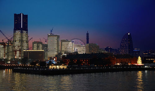 Illuminated city at waterfront