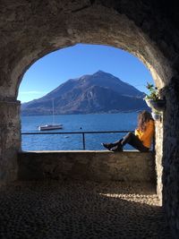 Woman on sea shore against sky