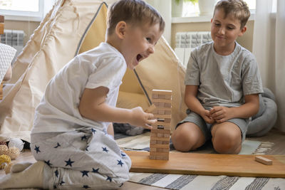 Family playing with toy blocks at home