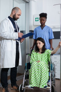 Portrait of female doctor examining patient in office