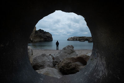 Scenic view of sea and rock formation against sky