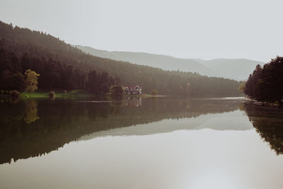 Mountains and trees reflecting on lake like a mirror in autumn