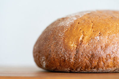 Close-up of bread on table against white background
