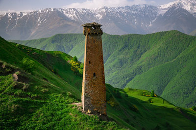 View of tower against mountain range