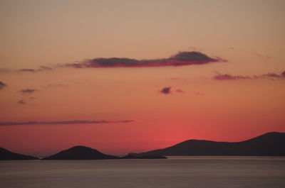 Scenic view of silhouette mountains against romantic sky at sunset