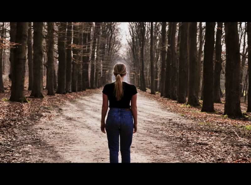 FULL LENGTH OF YOUNG MAN IN FOREST