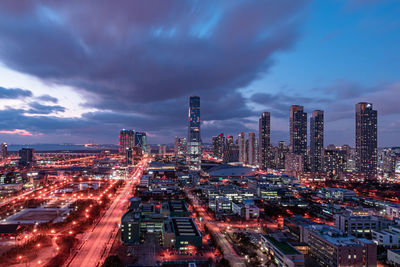 High angle view of illuminated buildings against sky at dusk