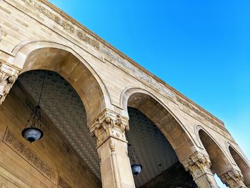 Low angle view of historical building against clear blue sky