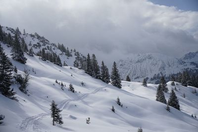 Scenic view of snow covered mountains against sky