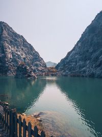 Scenic view of lake and mountains against clear sky