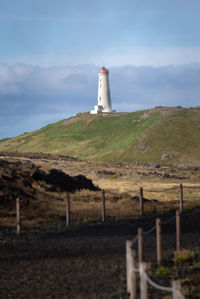 Reykjanes lighthouse on top of hill seen from gunnuhver hot springs area at reykjanes, iceland