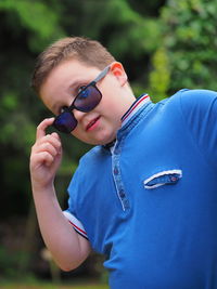 Portrait of a boy posing for a photo in sunglasses