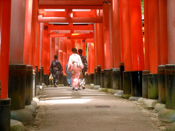 Rear view of people walking on street