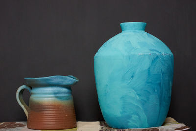 Close-up of pot on table against black background