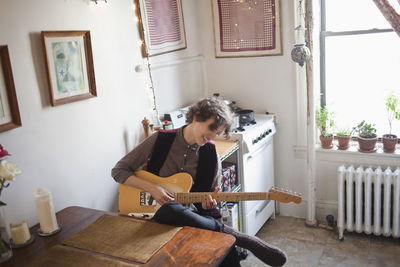 Young woman playing a guitar