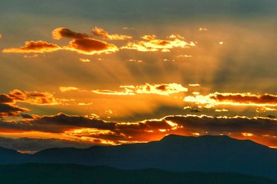 Scenic view of mountains against sky during sunset