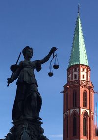 Low angle view of statue against sky