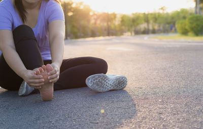 Low section of woman on road