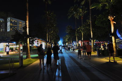 People on street in city at night