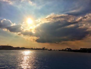 Scenic view of sea against dramatic sky during sunset