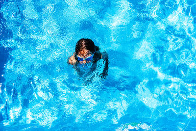 High angle view of woman swimming in pool