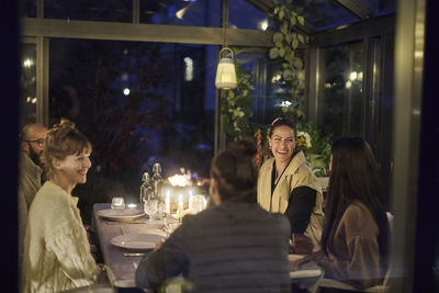 Happy friends having evening meal together